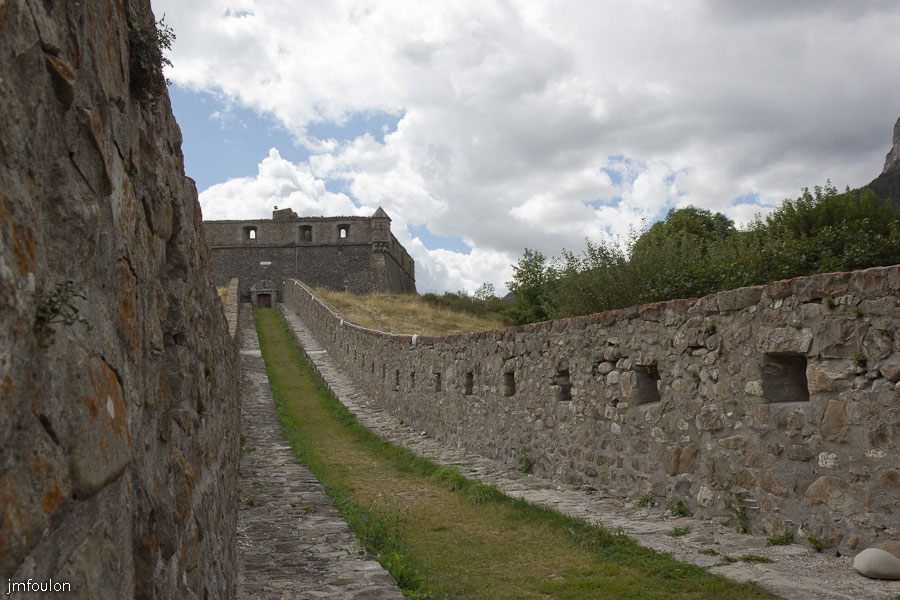 fort-france-01.jpg - Colmars-les-Alpes - le Fort de France est relié à la ville par une double caponnière qui permettait de quitter le fort pour rejoindre la ville close. Celle-ci est bordée de chaque côté d'un parapet en maçonnerie permettant de fournir des feux d'infanterie de part et d'autre de ce passage.